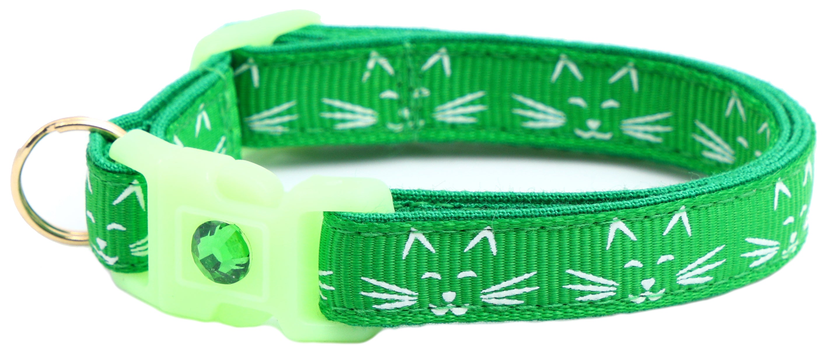 A glowing cat faces breakaway collar made of reinforced cotton, featuring a bell and charm, perfect for nighttime visibility.